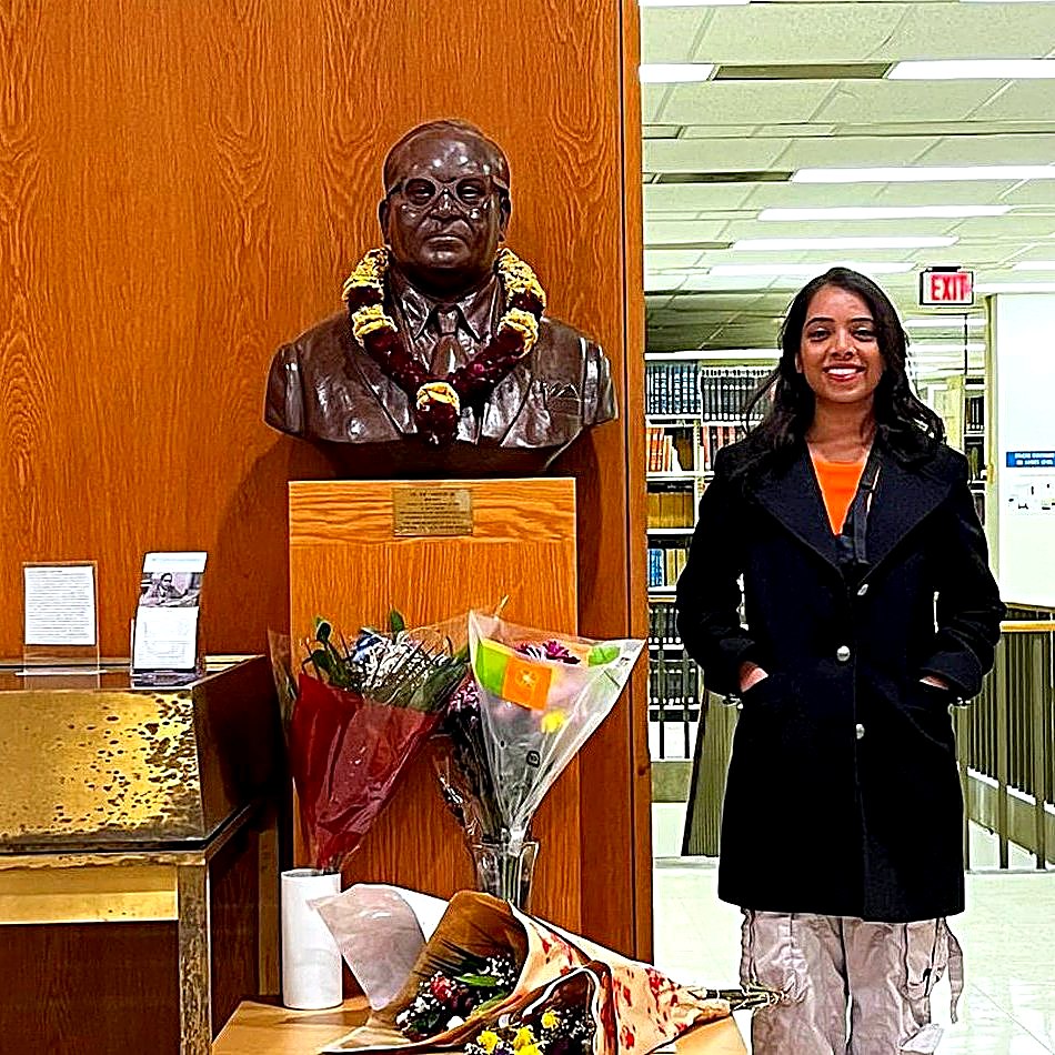 Komal Gajbhiye at the Dr. B. R. Ambedkar Memorial Bust at Columbia University, garlanded with marigolds